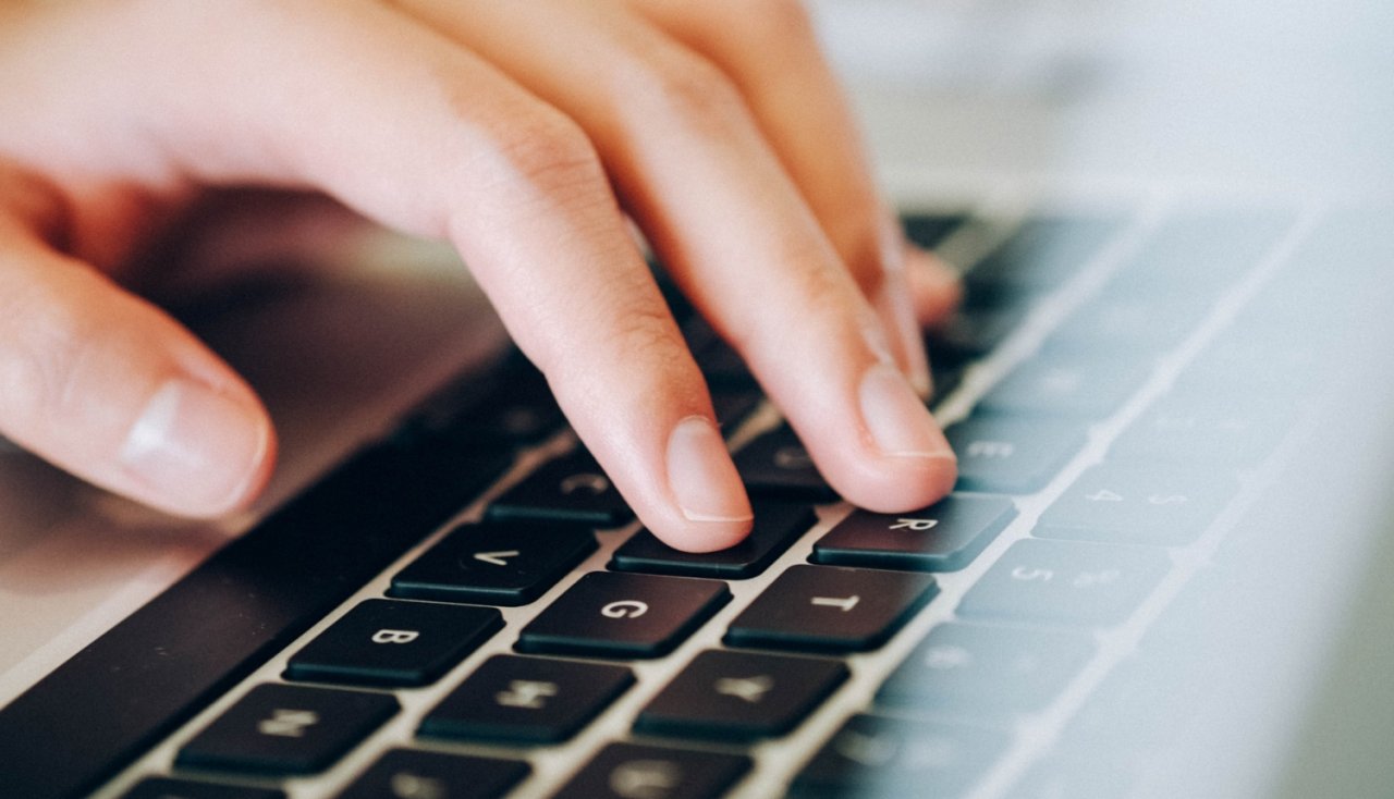 Close-up of hand on laptop keyboard