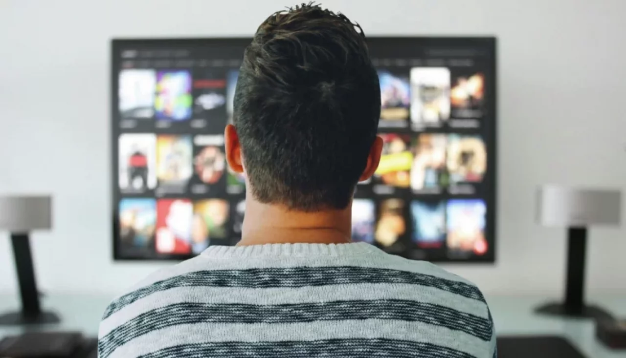 Man looking at the TV screen